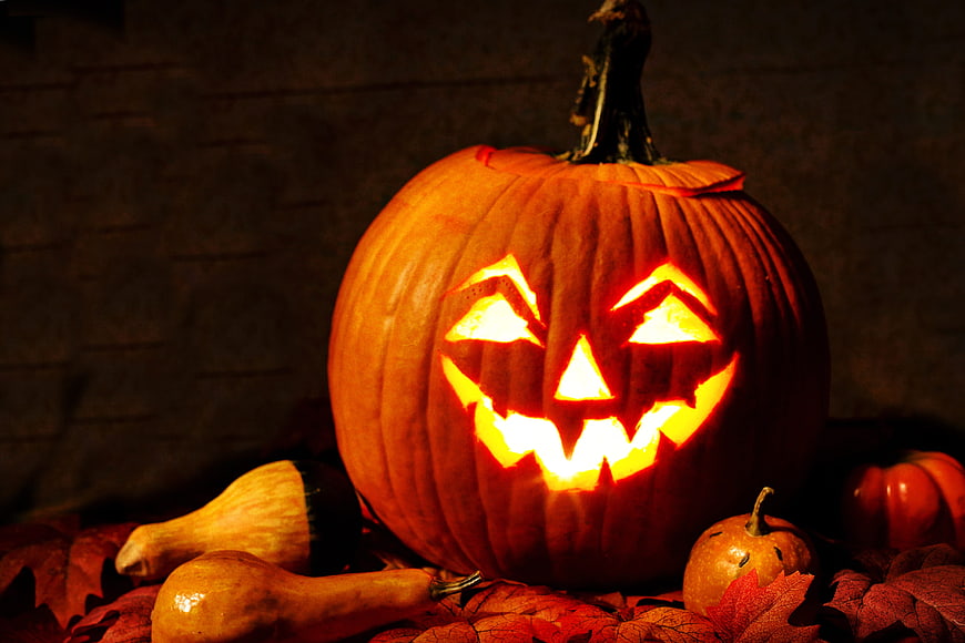 Glowing Jack-O-Lantern With Autumn Gourd And Maple Leaves