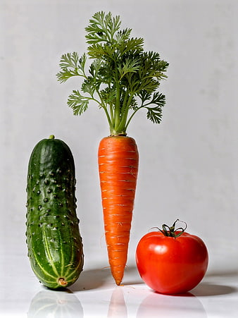 Fresh Cucumber, Carrot, and Tomato on White Background