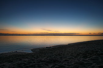 Serene Sunset Over Calm Ocean Beach Horizon