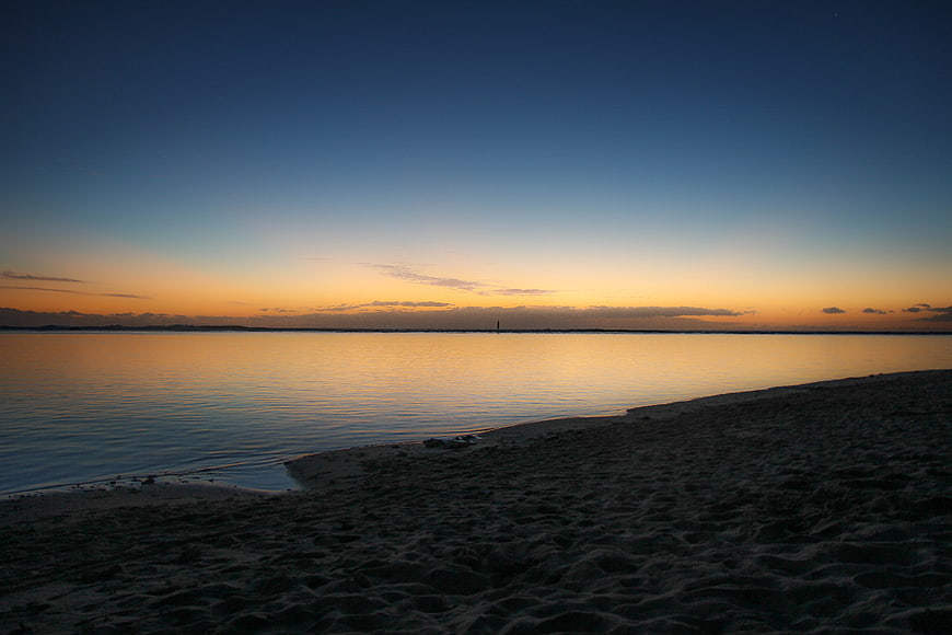 Serene Sunset Over Calm Ocean Beach Horizon