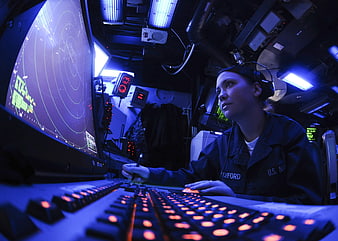 Female US Navy Radar Technician Operating Ship Control Console