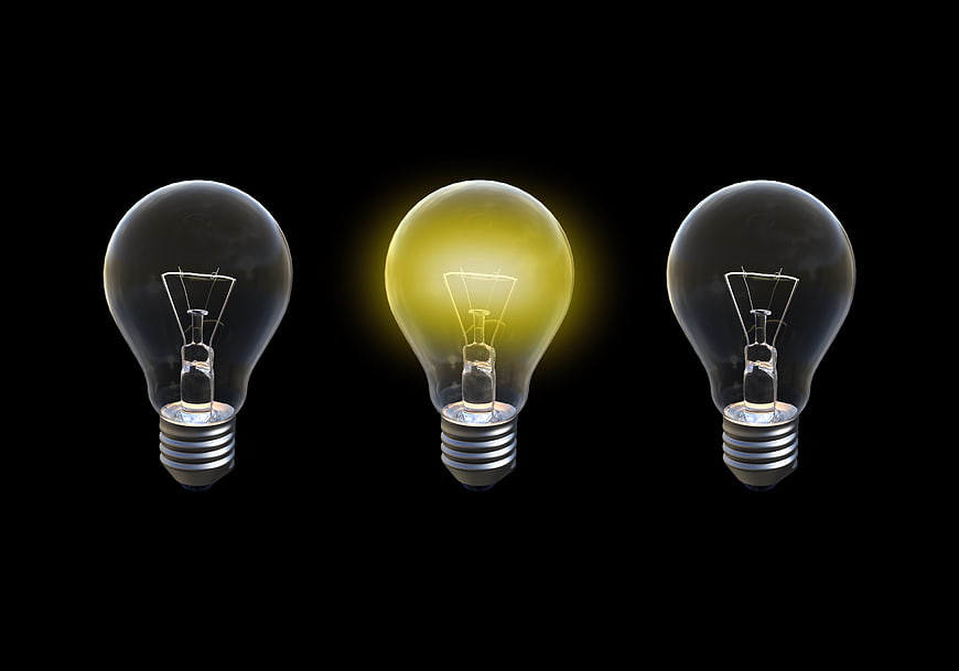 Three Light Bulbs With Center Illuminated On Black Background