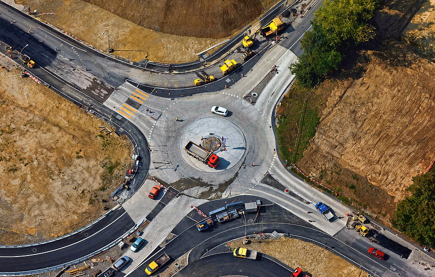 Aerial view of roundabout under construction with heavy machinery