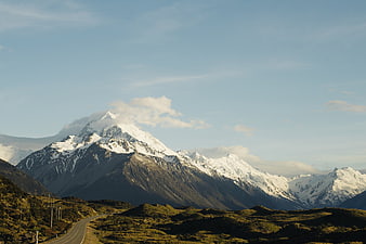 Snow-Capped Mountain Peak with Winding Road in Foreground
