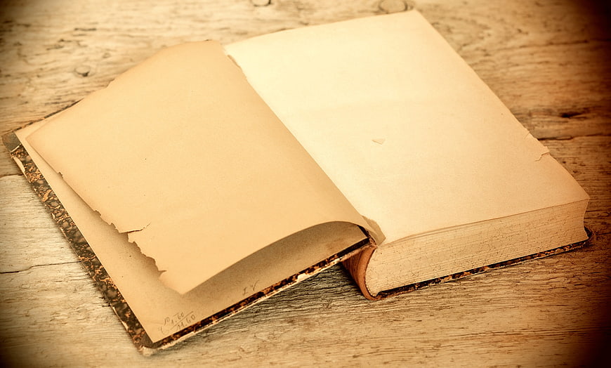 Vintage Open Book on Wooden Table with Empty Pages