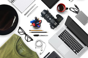 Flat lay of photographer workspace with camera, laptop, and accessories