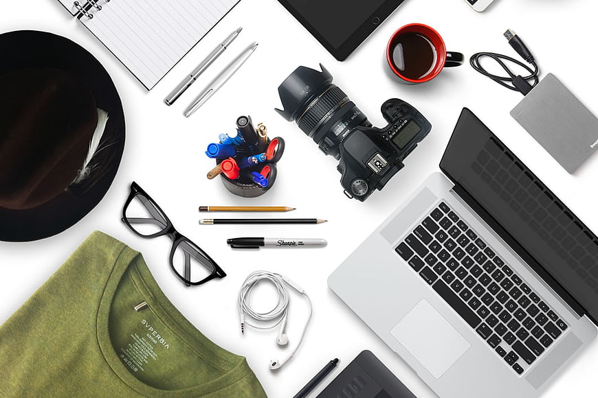Flat lay of photographer workspace with camera, laptop, and accessories