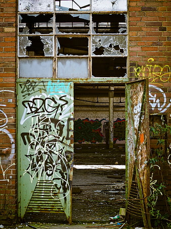 Abandoned Brick Building with Broken Windows and Graffiti