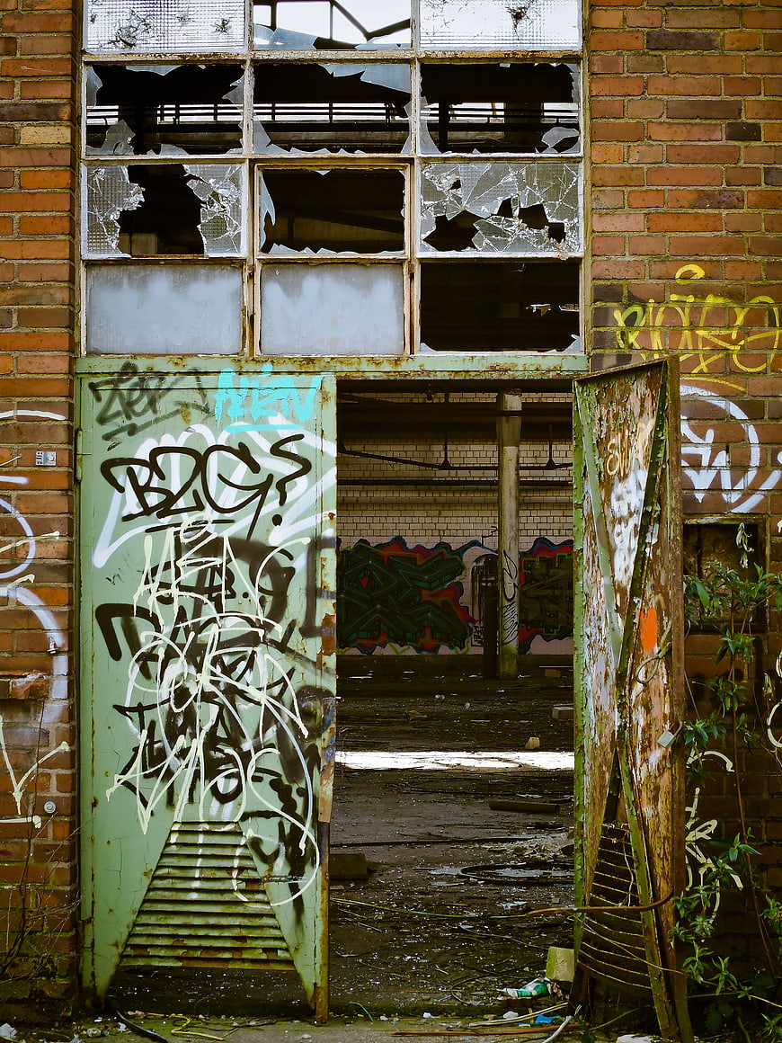 Abandoned Brick Building with Broken Windows and Graffiti
