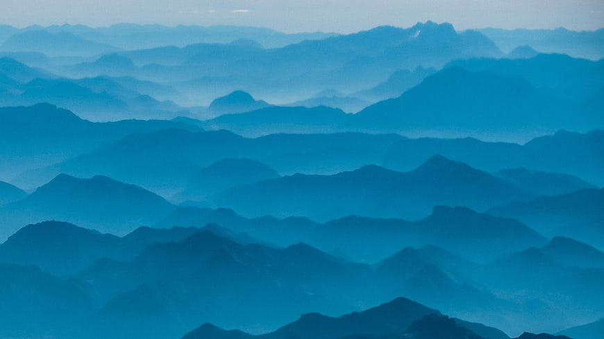 Layered Blue Mountain Ranges in Misty Fog