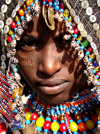 Close-up portrait of an Ethiopian woman wearing traditional colorful beadwork and jewelry