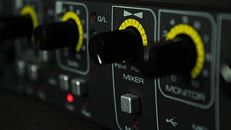 Close-up of audio mixer knobs and controls
