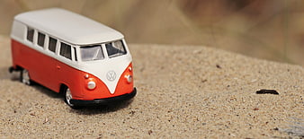 Vintage Red and White VW Camper Van Toy on Sand