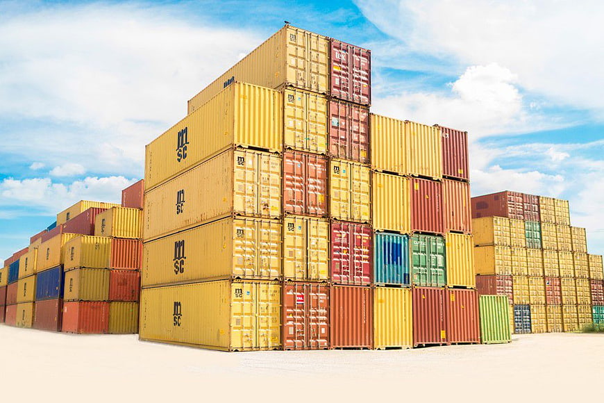 Stacked Colorful Shipping Containers in Logistics Yard