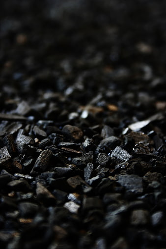 Close-up of black charcoal briquettes texture