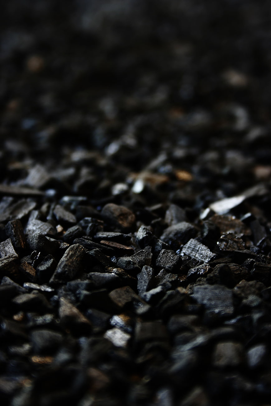 Close-up of black charcoal briquettes texture