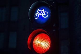 Close-up of bicycle traffic light with red signal at night