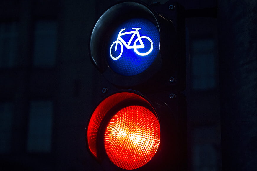 Close-up of bicycle traffic light with red signal at night