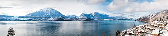 Panoramic winter view of Lake Thun and Swiss Alps