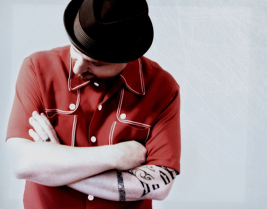 Man in Fedora and Red Shirt with Tattoos