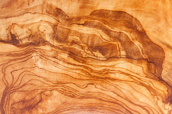 Close-up of natural olive wood grain texture with warm brown tones