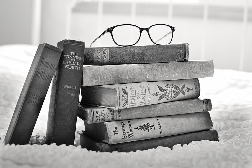 Vintage Books and Glasses on Bed