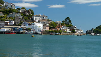 Scenic coastal town with harbor boats and hillside houses