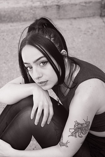 Black and white portrait of young woman with tattoos