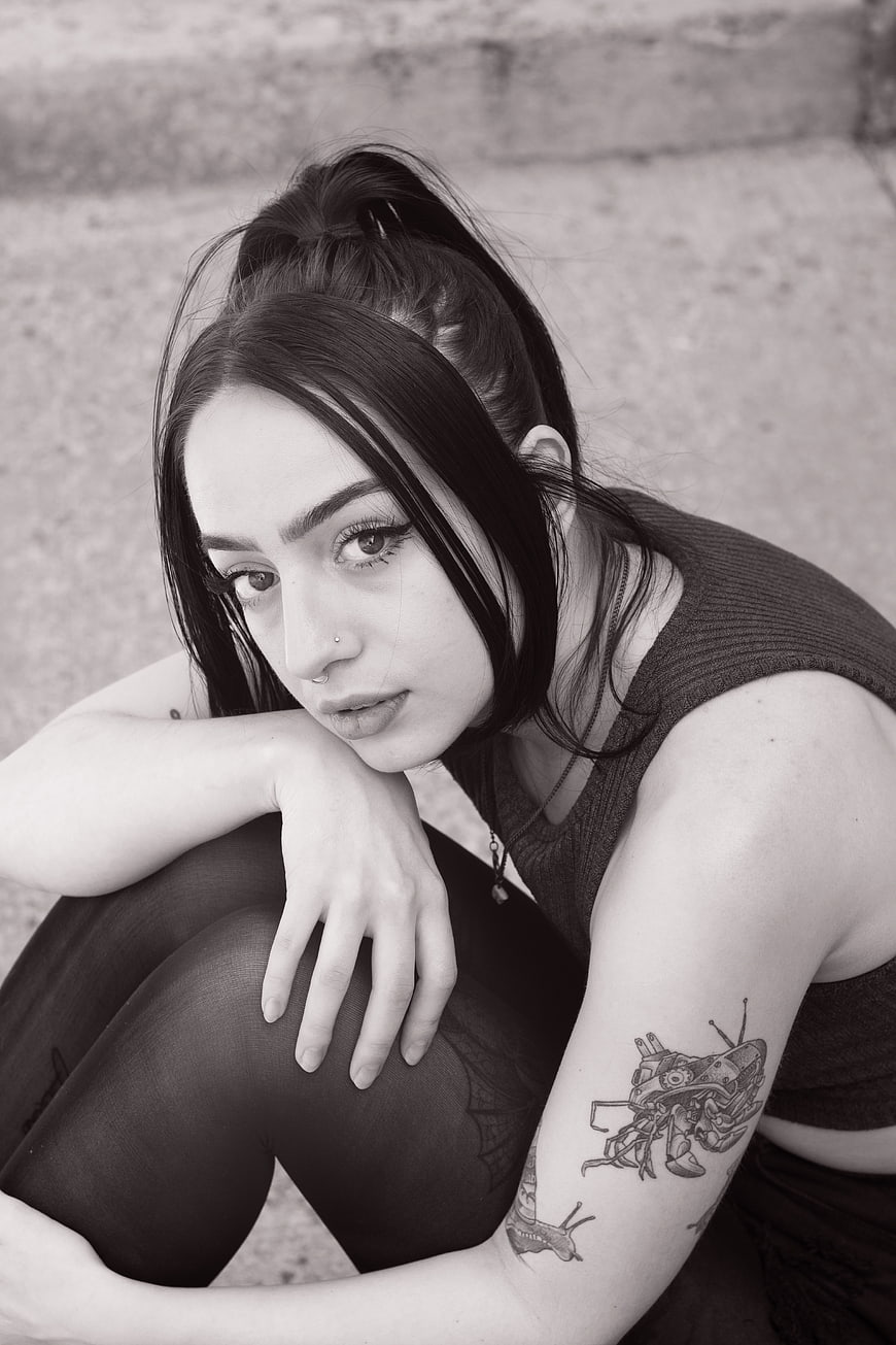 Black and white portrait of young woman with tattoos
