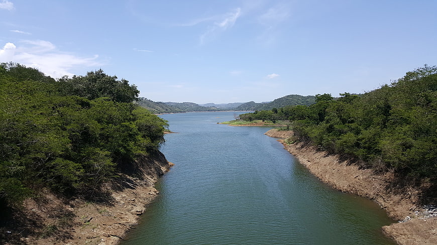 Wide river landscape with green banks and blue sky