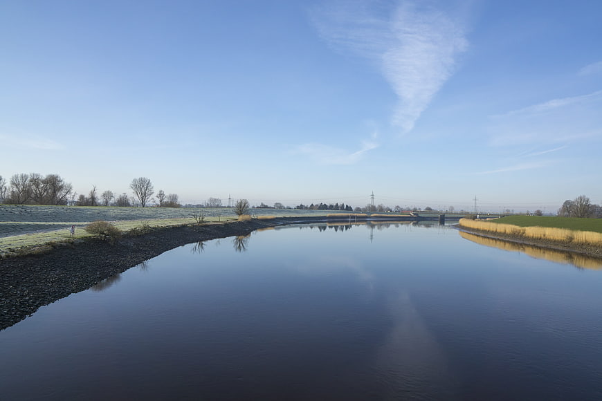 Serene River Landscape with Frosty Banks and Blue Sky