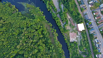 Aerial View of River, Forest, and Industrial Site