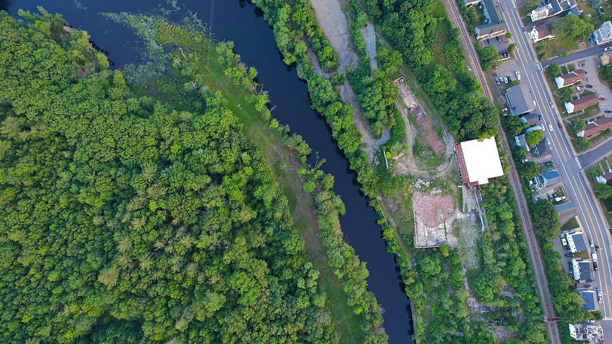 Aerial View of River, Forest, and Industrial Site