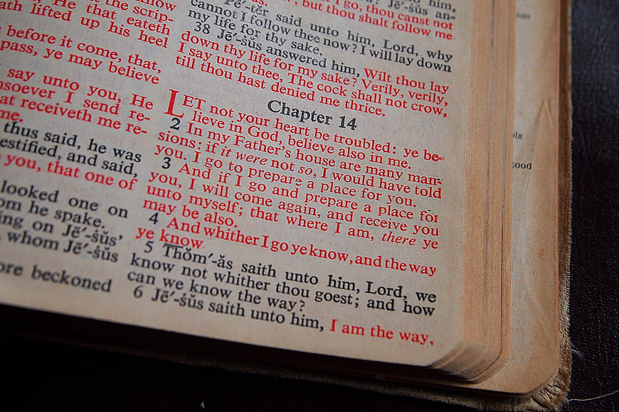 Close-up of Open Bible Page with Red and Black Text