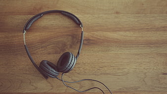 Black Wired Headphones on Wooden Surface