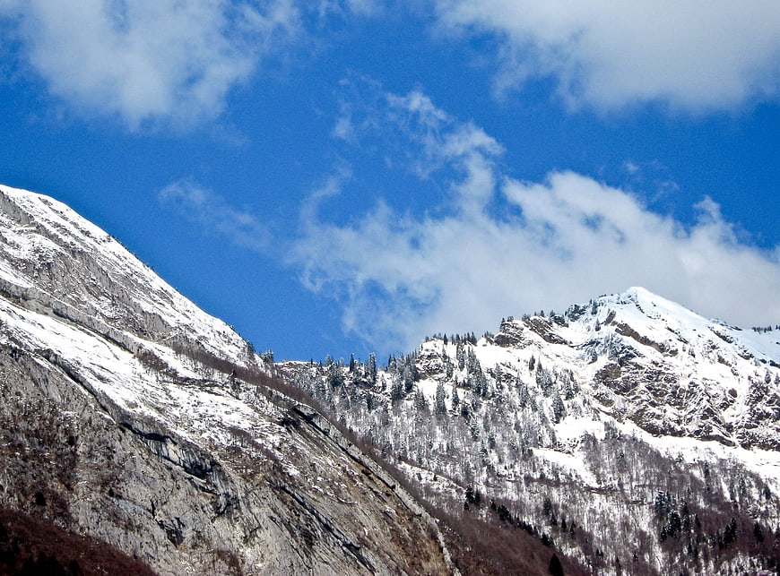 Snow-Covered Mountain Peaks Under Blue Sky