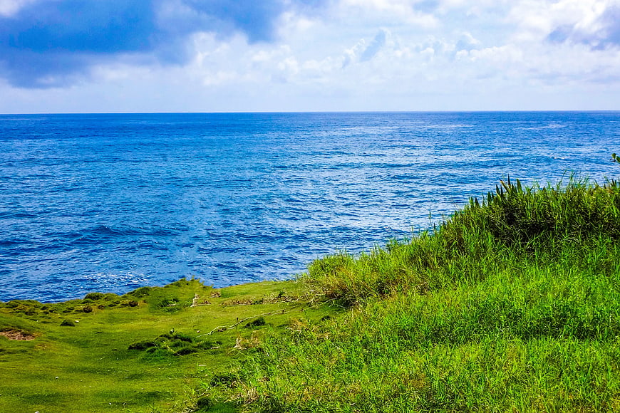 Vibrant Green Cliff Overlooking Deep Blue Ocean