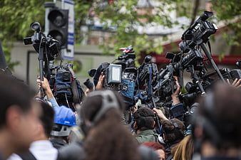 Crowd of journalists with cameras at press event