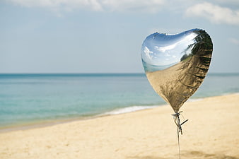 Silver Heart Balloon on Tropical Beach with Ocean View
