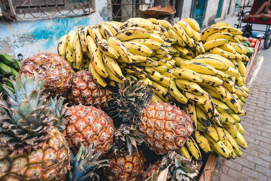 Fresh pineapples and ripe bananas at a Cuban street market