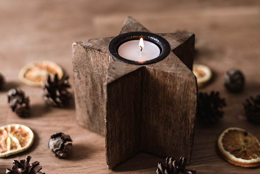 Rustic wooden star candle holder with tea light and dried orange slices