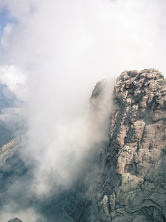 Misty Mountain Peak Emerging from Clouds