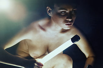 Cinematic Portrait of Woman Holding Glowing Light Tube in Dark