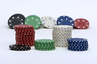 Colorful Poker Chips Stacked On White Background