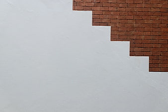Minimalist White Wall with Red Brick Corner Detail