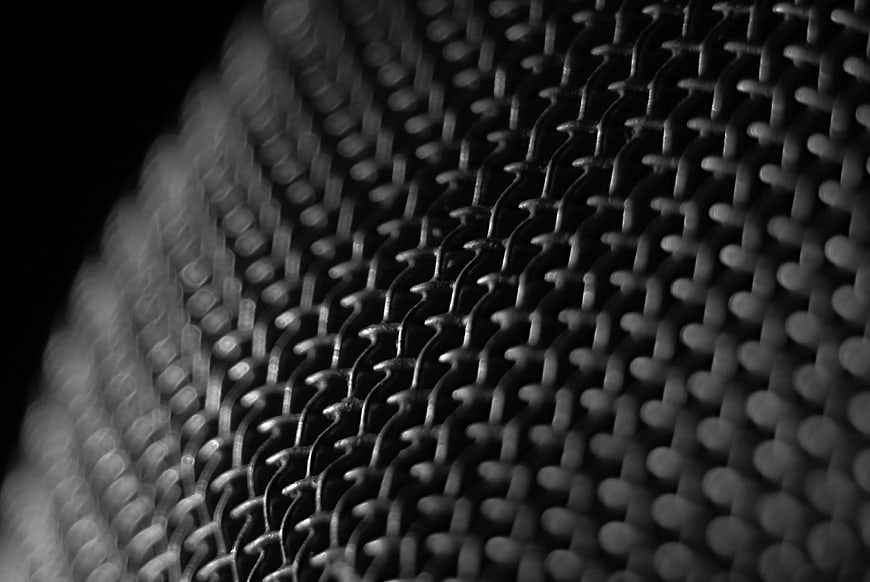 Close-up of black microphone windscreen mesh texture