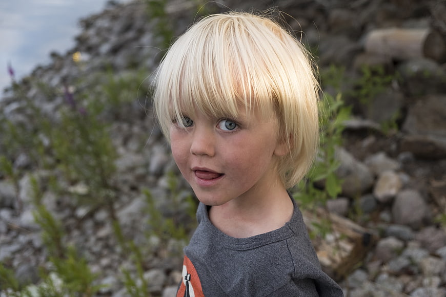 Portrait of a young blonde child outdoors