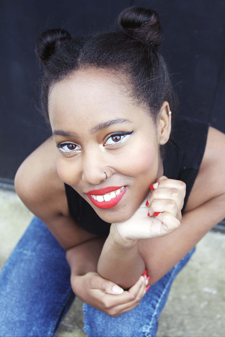 High Angle Portrait of Smiling Woman with Space Buns