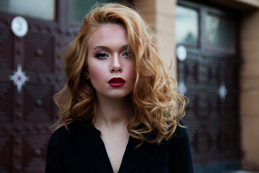 Portrait of Young Woman with Red Lips and Wavy Hair
