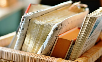 Vintage Books In Wicker Basket Close Up